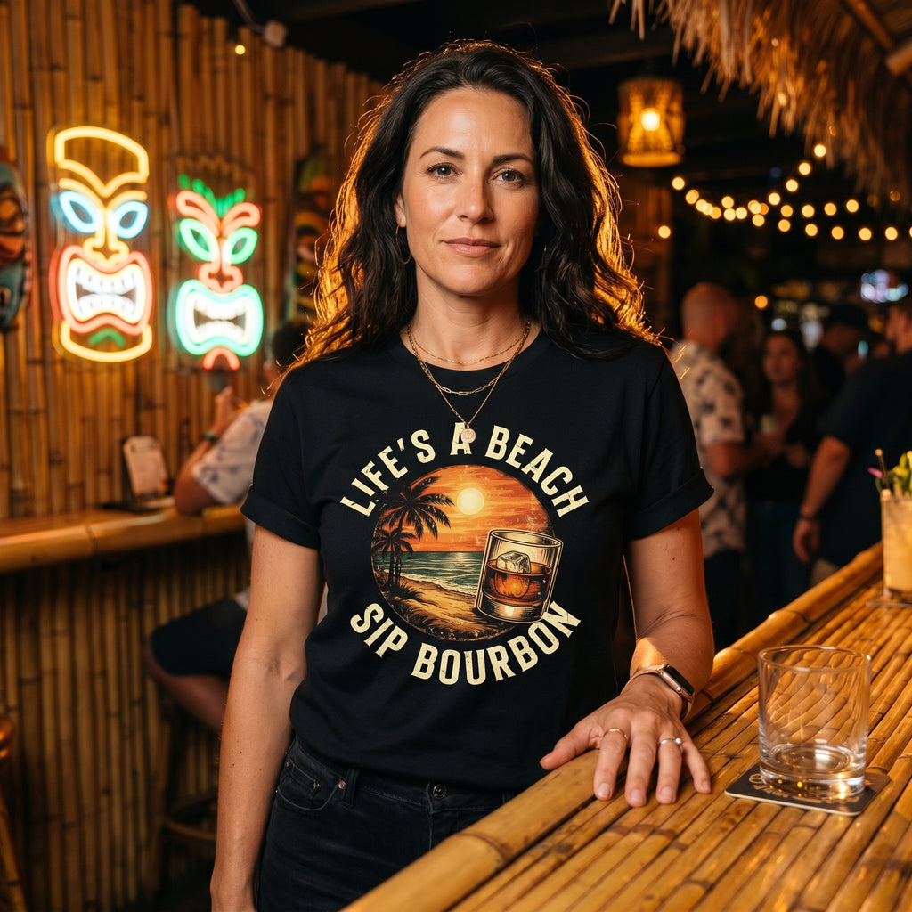 Woman wearing a t-shirt with 'Life's a Beach, Sip Bourbon' design in a bar setting.